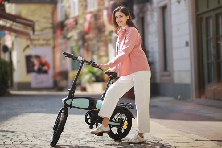 DYU C2 City E-Bike with rider standing along 