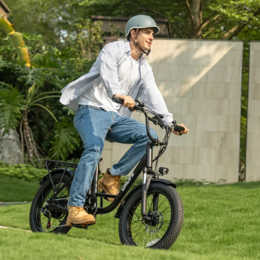 URLIFE E20 Fat Tyre E-Bike in Black-rider with helmet indoor ride